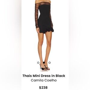 Camila Coelho black mini dress with mesh sleeves and flower design on hem.